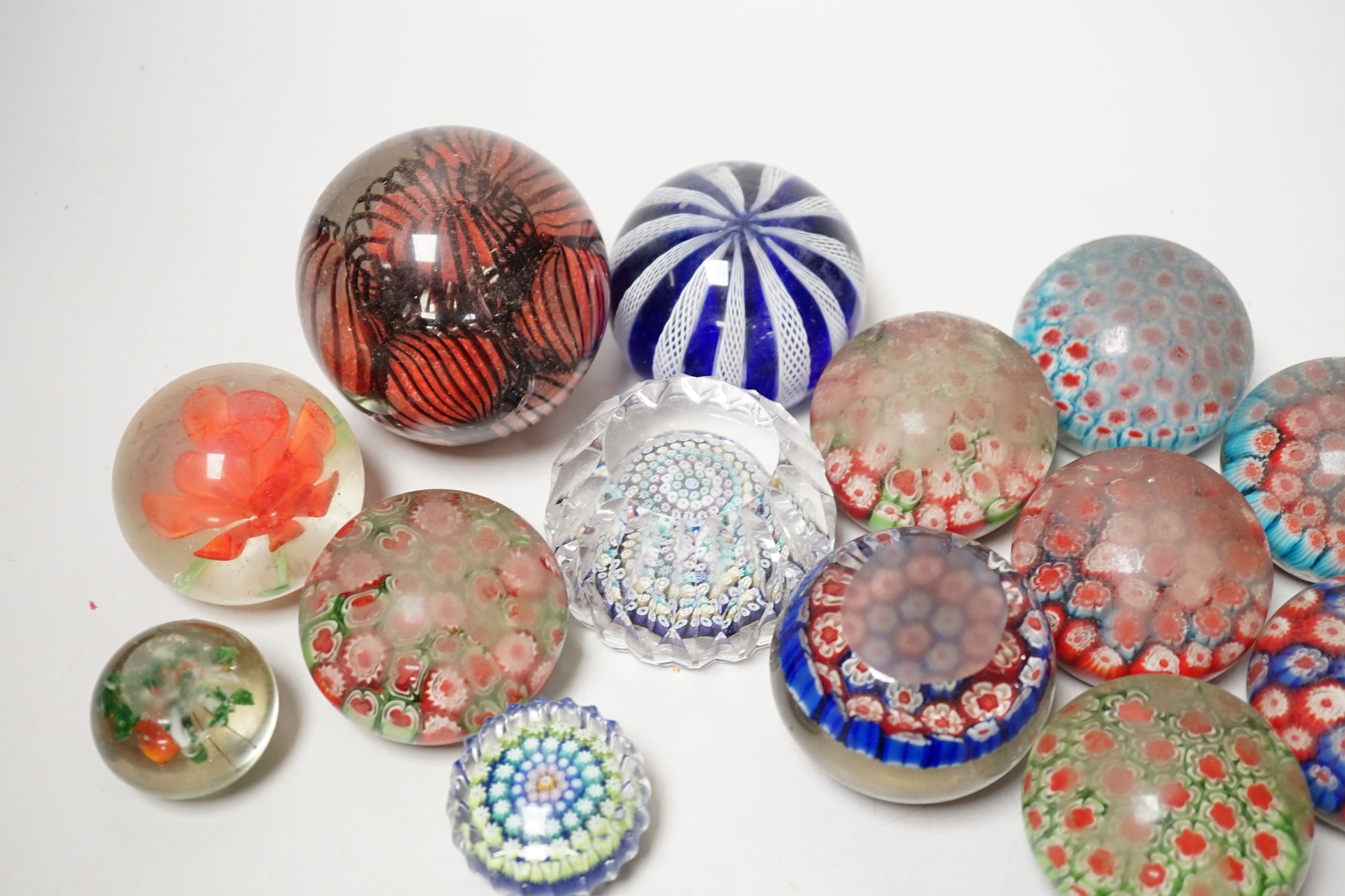 A group of assorted glass paperweights, including a Perthshire type close-packed millefiori paperweight